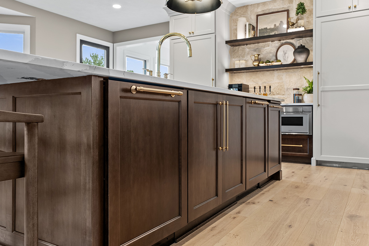 White and dark stained kitchen cabinets with white counter.