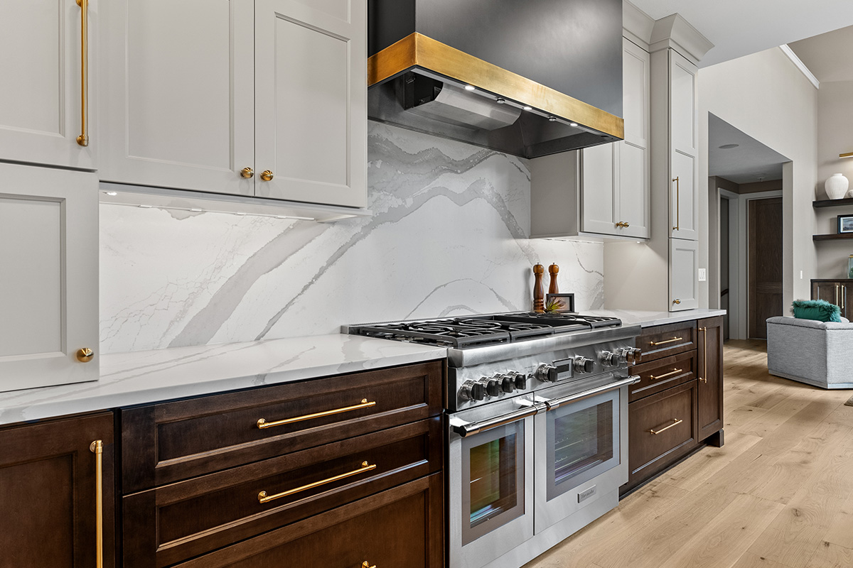 White and dark stained kitchen cabinets with white counter.