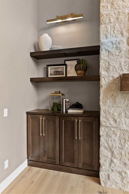 Dark stained bar cabinet and floating shelves