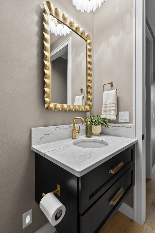 Dark green painted floating vanity with two drawer look in a bathroom.