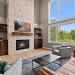Fireplace with dark stained cabinets on each side.