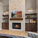 Fireplace with dark stained cabinets on each side.
