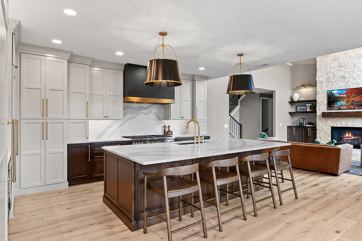 White and dark stained kitchen cabinets with white counter.