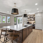 White and dark stained kitchen cabinets with white counter.
