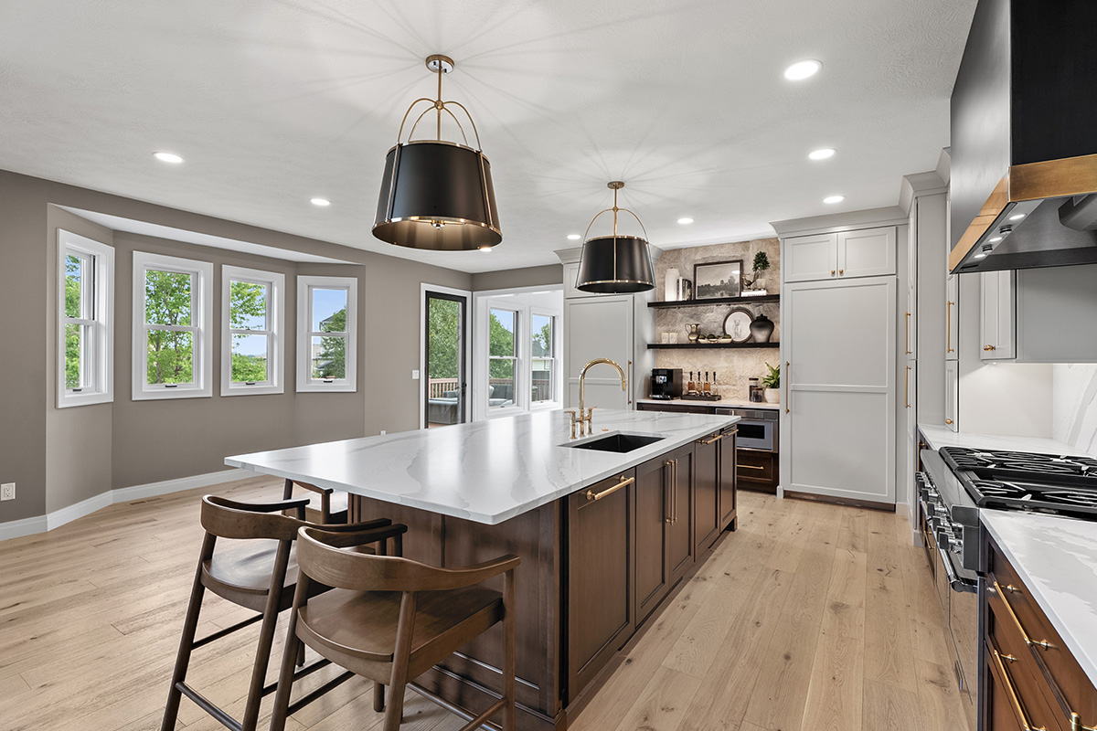 White and dark stained kitchen cabinets with white counter.
