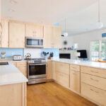 Modern Mid-Century kitchen with slab doors in maple natural