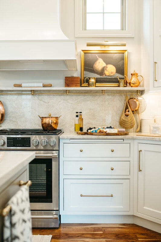 White kitchen cabinets with appetizers on the counter.
