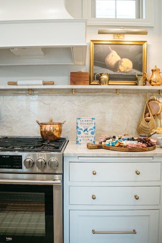 White kitchen cabinets with stainless steel stove.