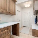 Brown stained mudroom with locker and bench seating and drop zone