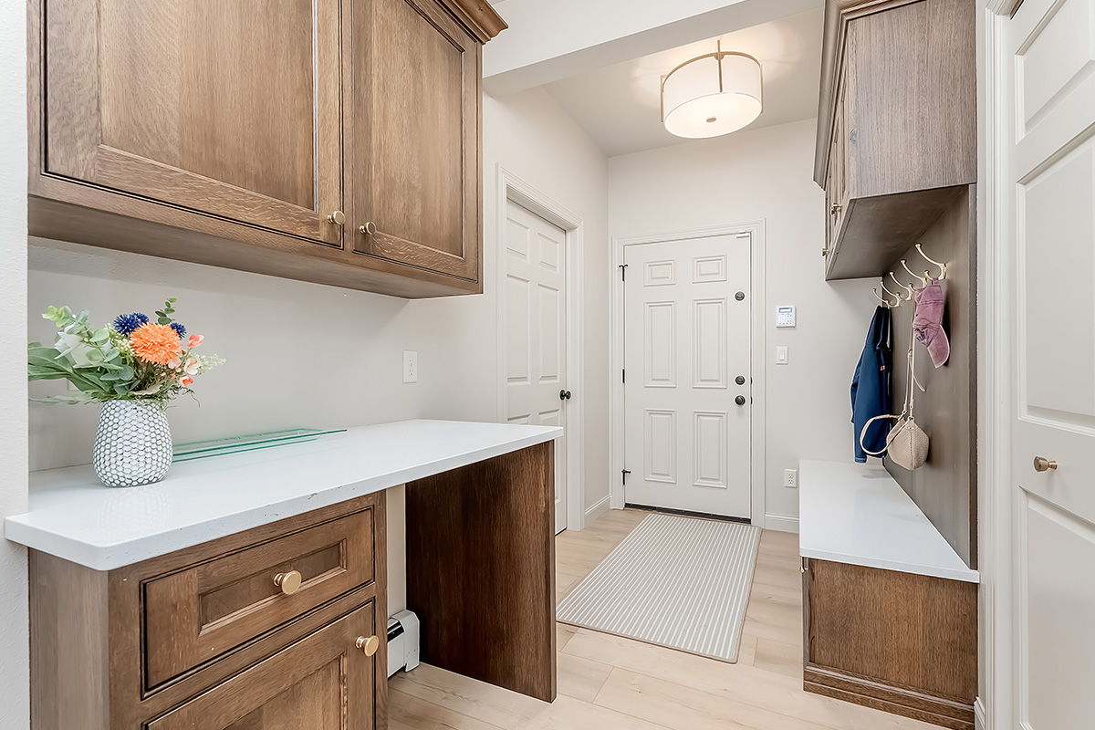 Brown stained mudroom with locker and bench seating and drop zone