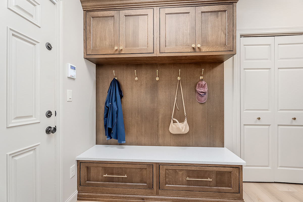 Brown stained mudroom with locker and bench seating