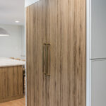 Ginger surface island cabinets and fridge panels.