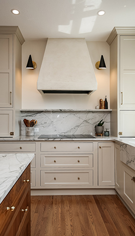 An off white inset kitchen cabinets with small knobs paired with walnut flooring and the island is made of walnut stained cabinets. This kitchen was designed by Showplace Cabinetry Design Center.