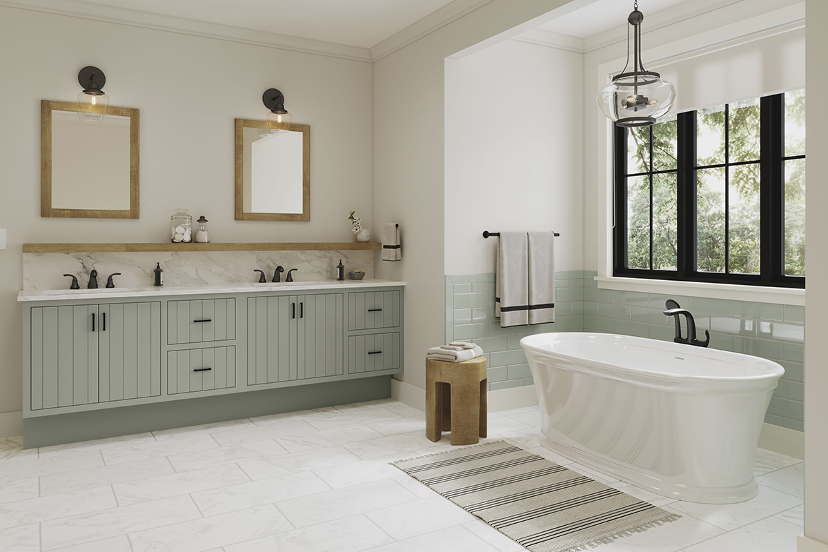 A view of the double vanity and the standing tub under the windows.